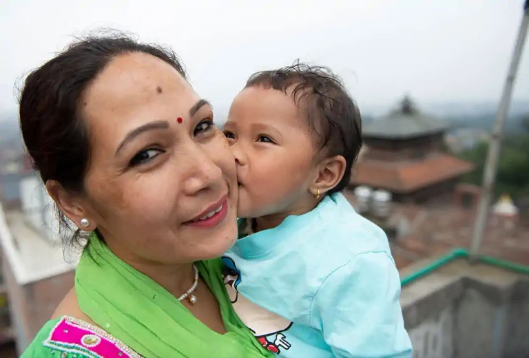A child kissing her mother after cleft care